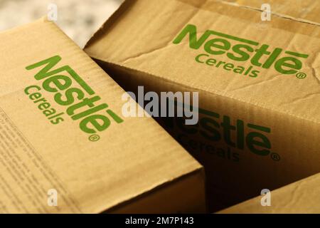 KYIV, UKRAINE - MAY 4, 2022 Big cardboard boxes with logo of Nestle company. Porduction storage of nestle goods Stock Photo