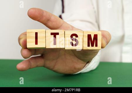 In the man's hand are cubes with the inscription - ITSM. Stock Photo