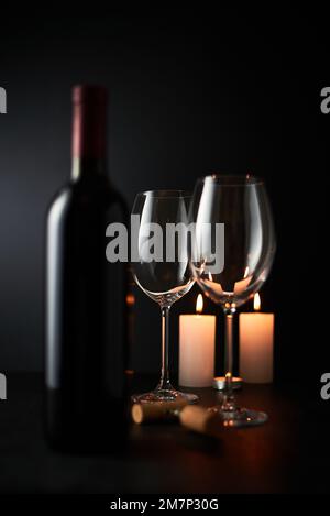 Empty Wine glass and Bottle on dark background. Stock Photo