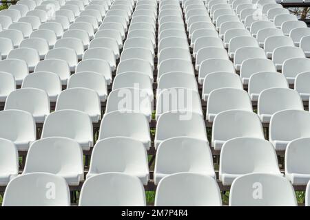 Seats of tribune on sport stadium. Concept of fans, chairs for audience, cultural environment concept. mpty seats, modern stadium. Stock Photo