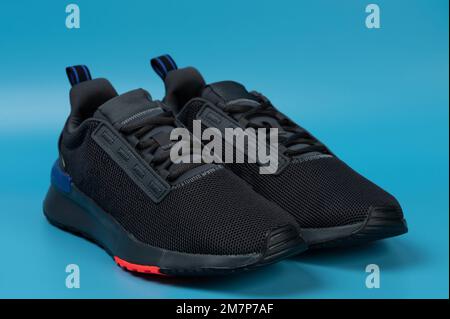 Black running shoes isolated on blue studio background Stock Photo
