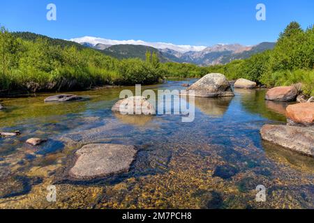 Big Thompson River - Summer blue sky reflected in clear and calm Big Thompson River in Moraine Park of Rocky Mountain National Park, Colorado, USA. Stock Photo