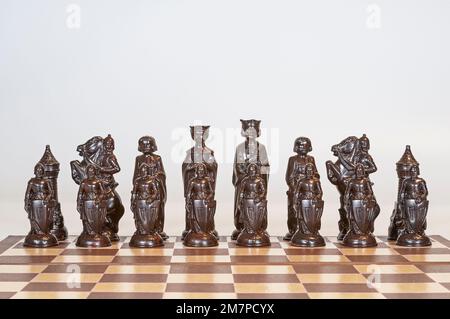 Black or dark-colored highly detailed chess pieces in initial starting positions.  Modeled after a 15th-century Renaissance set. Stock Photo