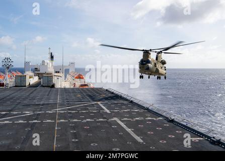 PACIFIC OCEAN (May 11, 2022) – A CH-47 Chinook helicopter, assigned to the 25th Combat Aviation Brigade, prepares to land on the flight deck of Military Sealift Command hospital ship USNS Mercy (T-AH 19) while underway for Pacific Partnership 2022. Now in its 17th year, Pacific Partnership is the largest annual multinational humanitarian assistance and disaster relief preparedness mission conducted in the Indo-Pacific. Stock Photo