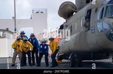 PACIFIC OCEAN (May 11, 2022) – U.S. Navy Sailors wait for a signal on the flight deck of Military Sealift Command hospital ship USNS Mercy (T-AH 19) while underway for Pacific Partnership 2022. Now in its 17th year, Pacific Partnership is the largest annual multinational humanitarian assistance and disaster relief preparedness mission conducted in the Indo-Pacific. Stock Photo