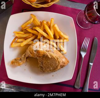 Tasty homemade chicken legs with fried potato Stock Photo