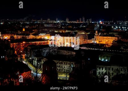 Kyiv, Ukraine - January 10, 2022: Night view of the city center. A bird's eye view of the Podil district in Kyiv. Ferris wheel. Peaceful New Year's Ky Stock Photo