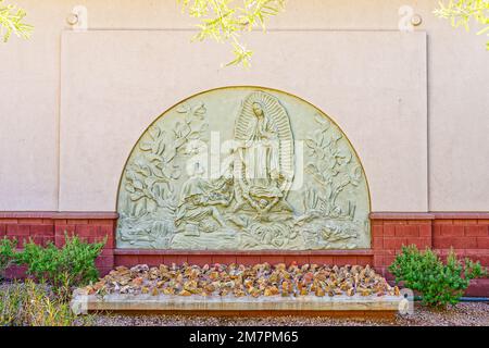 Phoenix, AZ - Nov. 12, 2022: This bas relief of the miracle of Our Lady of Guadalupe with Juan Diego is at Virginia Piper Plaza outside St. Mary's Rom Stock Photo