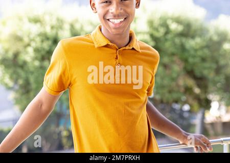 Image of biracial man in orange short sleeve polo t shirt with copyspace Stock Photo