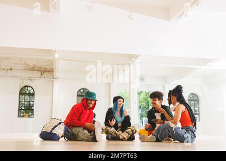 Image of low section of group of group of diverse female and male hip hop dancers in studio Stock Photo