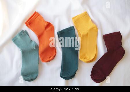 Isolated colorful socks with stripes on white background. Stock Photo