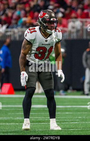 Mike Davis of the Atlanta Falcons is tackled by Antoine Winfield