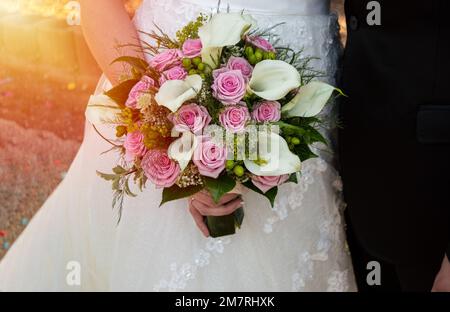 Shot of an unrecognizable woman holding a bouquet of flowers at a wedding Stock Photo