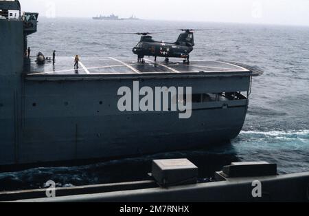 A left side view of a UH-46 Sea Knight helicopter on the flight deck of an ammunition supply ship. Country: Mediterranean Sea (MED) Stock Photo