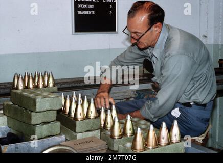 A civilian worker gages standard contour 557 artillery fuses at the Seneca Army Depot. Base: Romulus State: New York (NY) Country: United States Of America (USA) Stock Photo