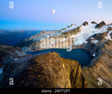 Moon rise after sunset over Mount Daniel from near the summit of Dip Top Peak in the Alpine Lakes Wilderness Stock Photo