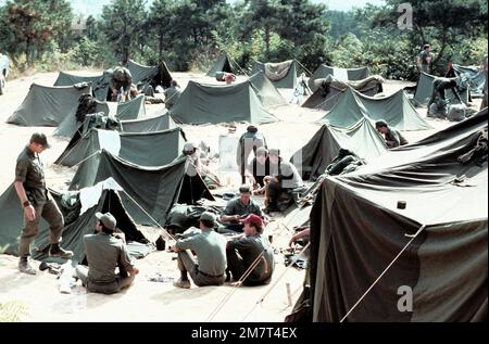 Airmen relax in a main encampment during a joint Red Horse Team mobility training exercise. The airmen are from the 554th Civil Engineering Squadron. Base: Camp Stalion Country: South Korea Stock Photo