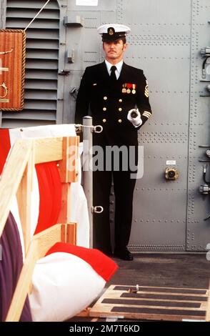Puget Sound Naval Shipyard, Bremerton, Washington. CHIEF Quartermaster Edmund H. Giles, with long glass in hand, mans the quarterdeck of the USS TAURUS (PHM 3) as the first officer of the deck during the commissioning for the hydrofoil. Base: Bremerton State: Washington (WA) Country: United States Of America (USA) Stock Photo