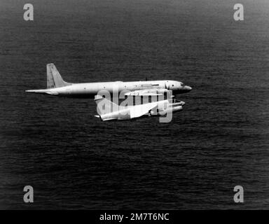 An air-to-air right side view of a Soviet Il-38 Ilyushin aircraft, NATO designation 'May,' and a U. S. Navy A-73 Corsair II aircraft from Attack Squadron 27 (VA-27) assigned to Carrier Air Wing 14 (CVW-14). The smaller U.S. Navy aircraft is being piloted by LCDR Dave Park. Country: Unknown Stock Photo