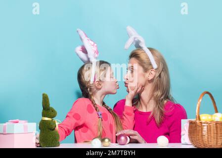 Family easter. Ester for mother and daughter. Mom with daughter kissing. Mother and child wearing bunny ears. Easter banner, poster flyer header for Stock Photo