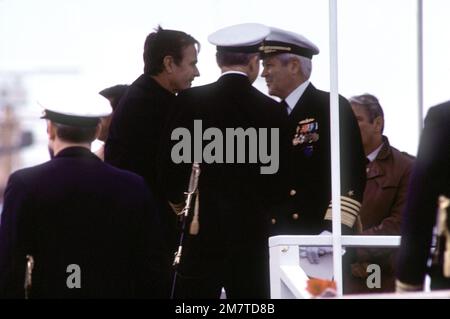 Vice President George Bush and ADM Harry D. Train II, center, greet each other as ADM Thomas B. Hayward, back to camera, looks on during the commissioning of the nuclear-powered ballistic missile submarine USS OHIO (SSBN-726). The OHIO was built by General Dynamics Corp. Base: Naval Submarine Base, Groton State: Connecticut (CT) Country: United States Of America (USA) Stock Photo