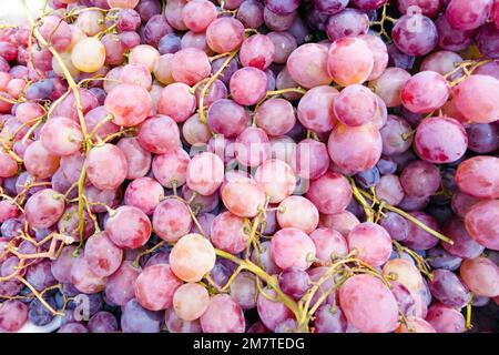 Bunch of red grapes on a supermarket shelf. background. close-up Stock Photo