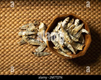 dried anchovies in a wooden bowl Stock Photo