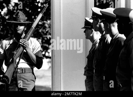 STAFF Sergeant Robert E. Brown demonstrates for his class of candidates the proper way to execute a movement during a drill session at the Aviation Officer Candidate School. Base: Naval Air Station, Pensacola State: Florida (FL) Country: United States Of America (USA) Stock Photo