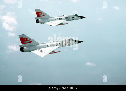 An air-to-air right rear view of two F-106 Delta Dart aircraft from the 87th Fighter Interceptor Squadron. Base: Charleston State: South Carolina (SC) Country: United States Of America (USA) Stock Photo