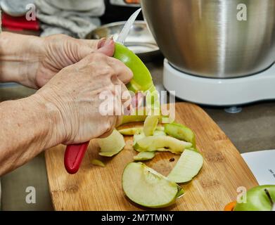 Chef cuts apples to make an apple pie. Step by step recipe. Stock Photo