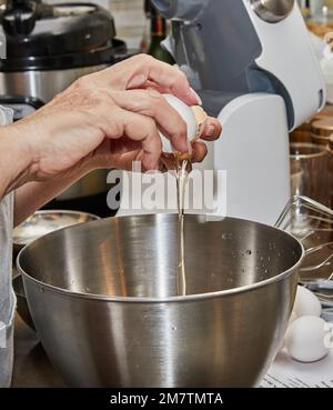 Chef separates the yolk from the protein to make the pie. Stock Photo
