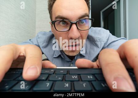 Funny and crazy man using a computer on white background. man's hands on keyboard Stock Photo