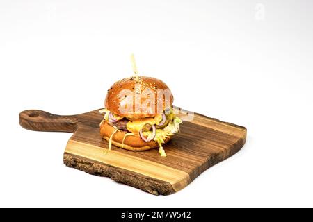 Fresh homemade hamburger on wooden serving board . White background with copy space. Stock Photo