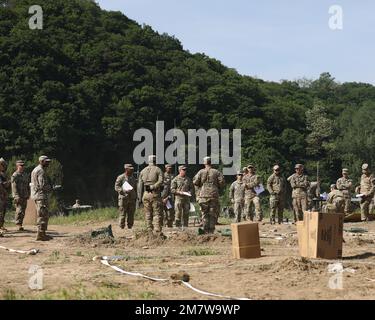 The brigade's S3 current operations team briefs leaders using a detailed terrain model for the upcoming exercise during the brigade's combined arms rehearsal (CAR) at a river crossing training area, Republic of Korea, on May 14, 2022; the CAR's purpose was to synchronize the brigade's actions during the exercise, providing effective training to the unit. Soldiers from across the 1st Armored Brigade Combat Team “Ready First”, 1st Armored Division (the current 2nd Infantry Division (ROK-US Combined Division) rotational brigade) participated in the “Warrior Ready Strike” training exercise to incr Stock Photo