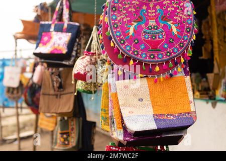 Colorful hand made traditional hand bags on sale at roadside market stall Stock Photo
