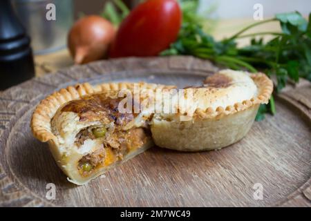 British ale steak Pie. Tender pieces of steak are cooked with vegetables and English ale, then wrapped in a flaky buttery crust. Stock Photo