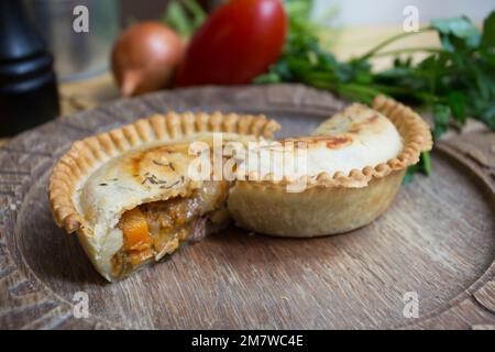 British ale steak Pie. Tender pieces of steak are cooked with vegetables and English ale, then wrapped in a flaky buttery crust. Stock Photo