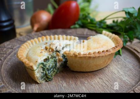 British spinach pie. Tender pieces of steak are cooked with vegetables and English ale, then wrapped in a flaky buttery crust. Stock Photo