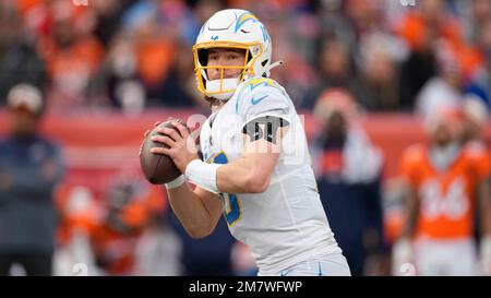 Los Angeles Chargers quarterback Justin Herbert (10) adjusts his helmet as  he warms up before an NFL football game against the Seattle Seahawks  Sunday, Oct. 23, 2022, in Inglewood, Calif. (AP Photo/Marcio