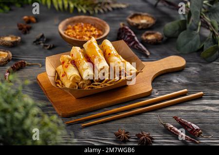 Deep fried spring rolls on a bed of noodles Stock Photo
