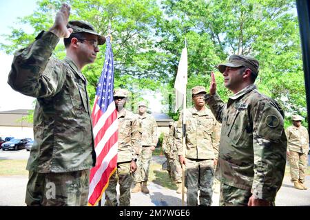 122nd Tactical Support Detachment Commander, Colonel John Fuchko administers the oath of enlistment to Staff Sergeant Ernest Churchwell as part of a small ceremony to recognize Churchwell’s reenlistment for three more years of service in the Georgia Army National Guard, May 14, 2022, at the Clay National Guard Center in Marietta, Ga. Stock Photo