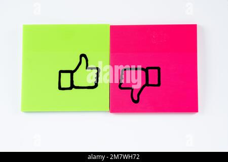 hand drawn graphic in black pen on color sticky notes thumbs up and down yes no isolated on a white background Stock Photo