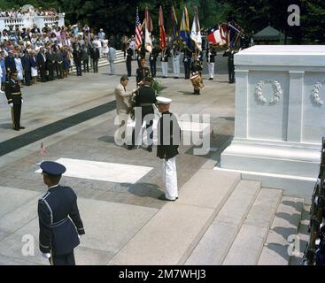 President Ronald Reagan places a wreath at the base of the casket of ...