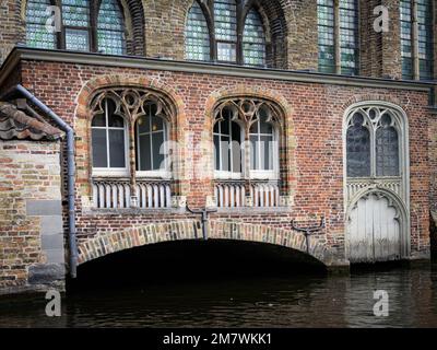 Bruges, Belgium-July 4, 2022: An old house with a small bridge, daylight, summer Stock Photo