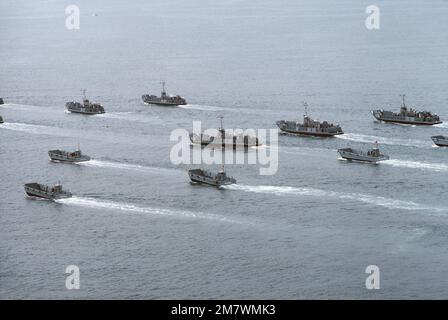 An aerial port quarter view of utility and mechanized landing craft attached to Assault Craft Unit One (ACU-1) during a practice landing at the Silver Strand area of North Island. Base: San Diego State: California (CA) Country: United States Of America (USA) Stock Photo