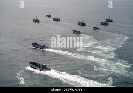 An aerial port quarter view of utility and mechanized landing craft attached to Assault Craft Unit One (ACU-1) during a practice landing at the Silver Strand area of North Island. Base: San Diego State: California (CA) Country: United States Of America (USA) Stock Photo