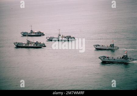 An aerial port bow quarter view of utility and mechanized landing craft during a practice landing at the Silver Strand area of North Island. They are attached to Assault Craft Unit One. Base: San Diego State: California (CA) Country: United States Of America (USA) Stock Photo