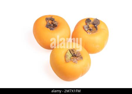 fresh persimmons on a white background Stock Photo