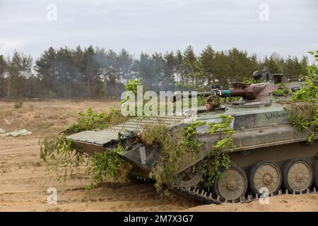 A Polish BMP-1 infantry fighting vehicle advances onto the battlefield at the start of a field training exercise as part of Defender Europe at Mielno Range, Poland, May 14, 2022. Defender Europe 22 is a series of U.S. Army Europe and Africa multinational training exercises in Eastern Europe. The exercise demonstrates U.S. Army Europe and Africa’s ability to conduct large-scale ground combat operations across multiple theaters supporting NATO. Stock Photo