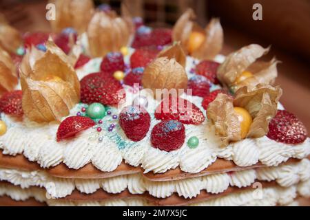 Strawberries and raspberries on a cake with whipped cream close-up Stock Photo